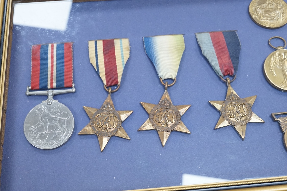 Framed group of eight WWI and WWII medals including a First World War medal pair, the Africa star, the Atlantic star, etc. a hallmarked silver boxing medal and another, both cased, plus a Lancashire and Cheshire Associat